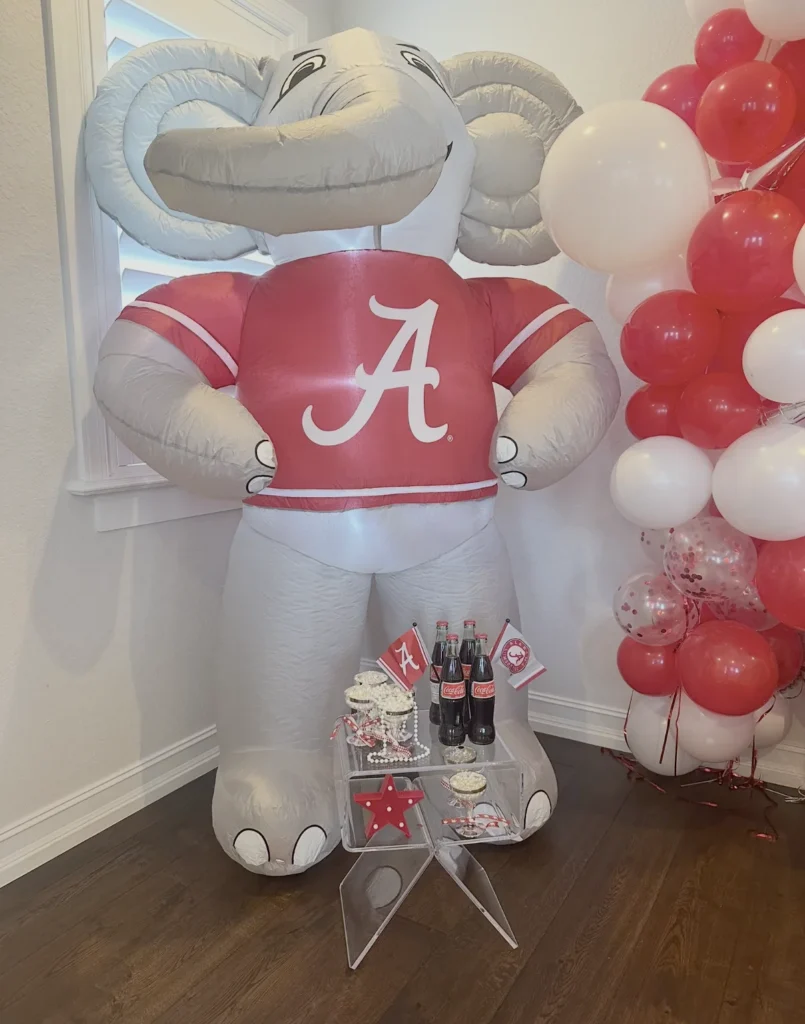 Alabama bed party with a giant inflatable elephant mascot, crimson and white balloon garland and a soda bar