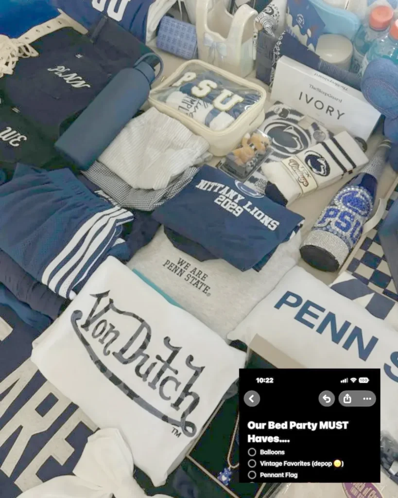 Penn State bed party gifts spread across the bed: PSU merch, pennants and treats
