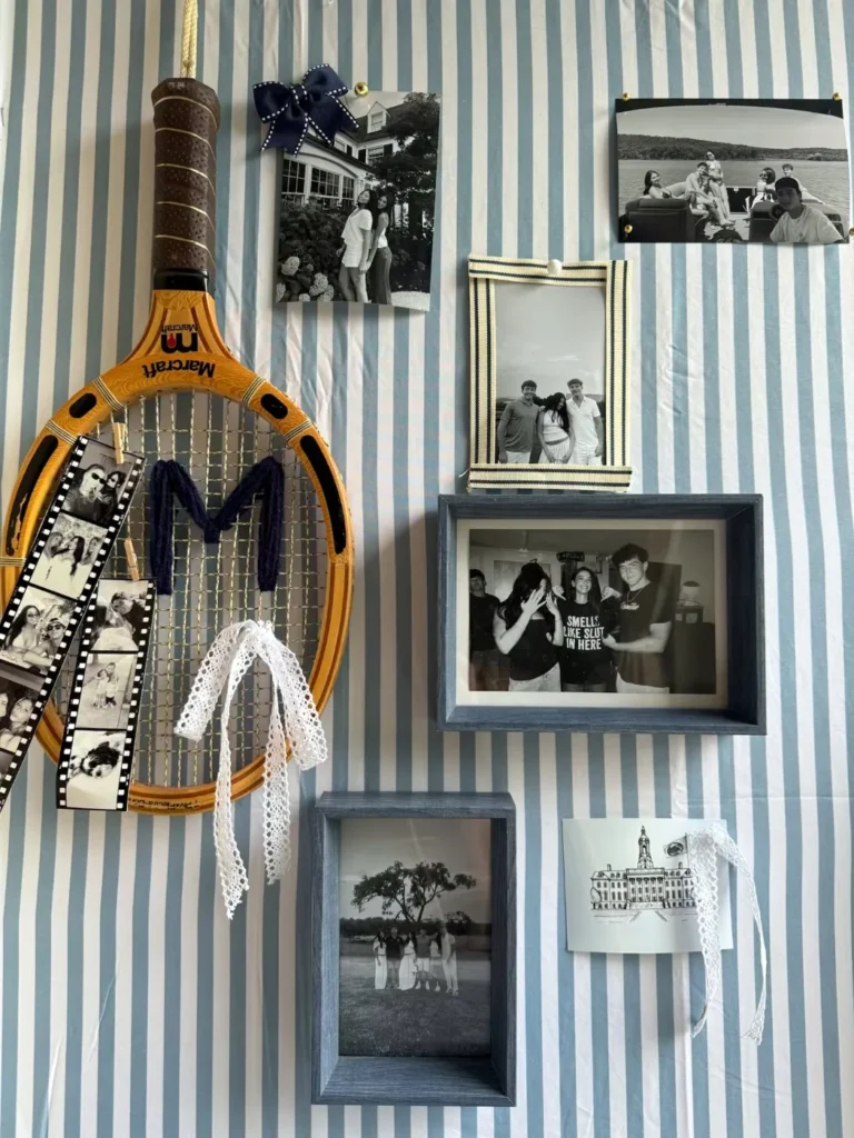 Tennis-themed dorm photo wall with striped wallpaper, a vintage racket and framed family photos